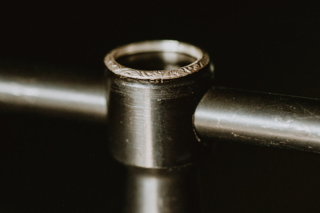 Dainty stacking ring in engraved triangle style with a sterling silver faceted finish