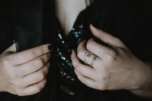 Women wearing a stackable 
ring set with five dainty stacking rings stacked together